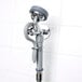 A T&S pre-rinse faucet with angled spray valve and hose on a wall.