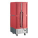 A red insulated full size hot holding cabinet with clear Dutch doors, universal wire slides, and wheels.