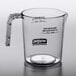 A clear glass Waring Belgian waffle batter pour cup on a counter.