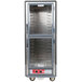 A gray Metro C5 hot holding cabinet with clear Dutch doors and lip load aluminum slides.