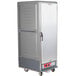 A large grey Metro C5 hot holding cabinet with a door on wheels.