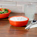 A Fiesta small china bowl filled with food on a table.