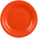 A close-up of a Fiesta® Poppy China dinner plate with a rim on it.