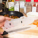 A hand holding a Victorinox knife in a plastic container.