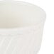 A close up of a CAC bone white fluted souffle bowl.