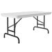 A gray rectangular Correll folding table with black legs.