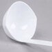 a white ladle with a long handle