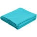 A teal hemmed Intedge poly/cotton blend table cover folded on a white background.