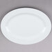 A Tuxton Alaska bright white china serving platter with a wide rim.
