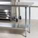 a stainless steel table with wheels