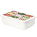 A Carlisle white container with different colored food in it.