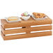 A Cal-Mil bamboo crate riser holding bowls of food on a table in a bakery.