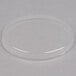 A clear plastic Mason jar lid on a white surface.