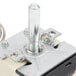 A Waring thermostat with a metal bolt and plastic and metal switch.