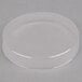 A clear plastic round lid over a white surface.