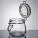 An American Metalcraft glass apothecary jar with a metal hinged lid.