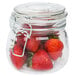 An American Metalcraft glass apothecary jar filled with strawberries.