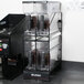 A Bunn 4 position hopper rack on a coffee machine with Bunn Smart Hoppers filled with coffee beans.