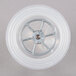 A white plastic wheel with a metal wheel in the middle.