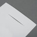 A white piece of paper with a cut out in it.