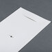 A white piece of paper with a hole in it
