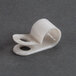 A white plastic cable clamp with holes.