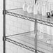 A Regency shelf with clear PVC liner holding white vases and glasses.