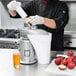 A man using a Waring juicer to make apple juice.