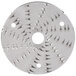 A circular metal Waring shredder disc with spikes on it.