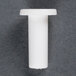 A white plastic cylindrical object with a cap on one end.