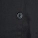 A black button on a black Chef Revival chef coat.