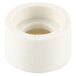 A close-up of a white plastic pipe fitting with a hole in it.