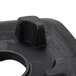 A close-up of a black rubber jar pad with a hole in it.