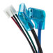 A close-up of a blue and white wire with a red and black connector.