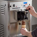 A person using the Spaceman Soft Serve Ice Cream Machine to make a soft serve ice cream cone.