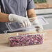 a person wearing gloves and holding a tray