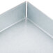 A close-up of a metal corner with a black surface