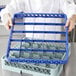 A chef using a blue Noble Products glass rack extender.