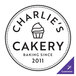 A white circle with black text and a cupcake on it with the text "Charlie's Bakery" and the Noble Products logo.