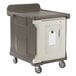 A brown and gray Cambro meal delivery cart with a large plastic container on wheels.