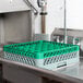 A Noble Products glass rack with green extenders on a stainless steel counter.