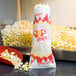 A Paragon jumbo paper popcorn bag in a red container.