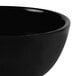 A close up of a black GET Elegance melamine bowl.