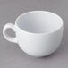 A white GET Diamond white mug with a handle on a gray surface.