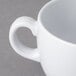 A close-up of a white GET Diamond White mug with a handle.