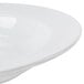 A CAC Harmony white porcelain soup bowl with a thin rim on a white surface.