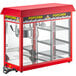 A red Carnival King popcorn machine with a glass door.