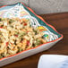 A GET Bella Fresco melamine tray with pasta salad and vegetables on a table.