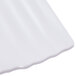 A close up of a white Polynesian square plate with a curved edge.