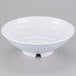 A white GET Milano melamine bowl with a spiral design on a gray surface.
